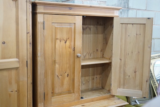 A modern pine dresser, enclosed by two pairs of fielded panelled doors, length 96cm, depth 45cm, height 178cm
